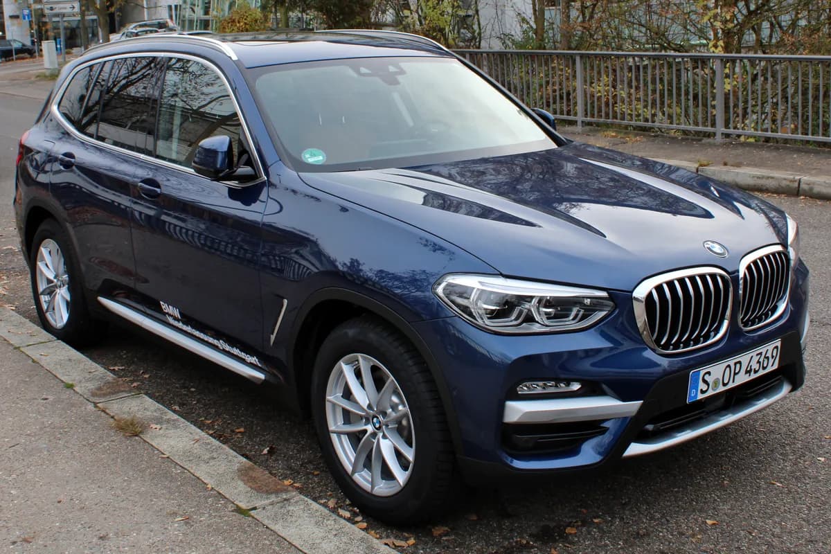A blue BMW X3 SUV, front three-quarter view