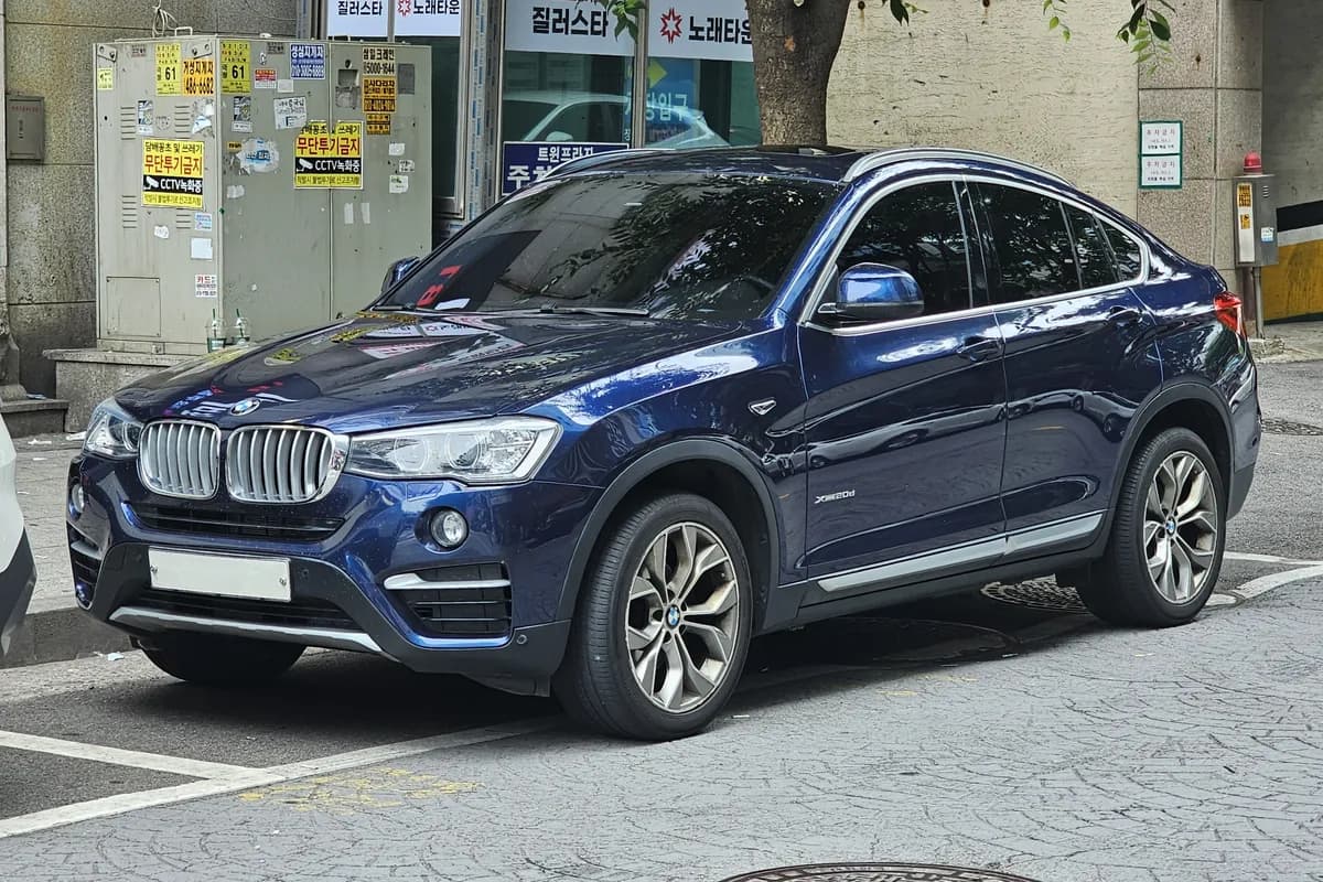 A blue BMW X4 SUV, front three-quarter view