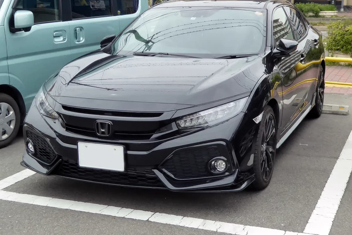 A black Honda Civic hatchback, front three-quarter view