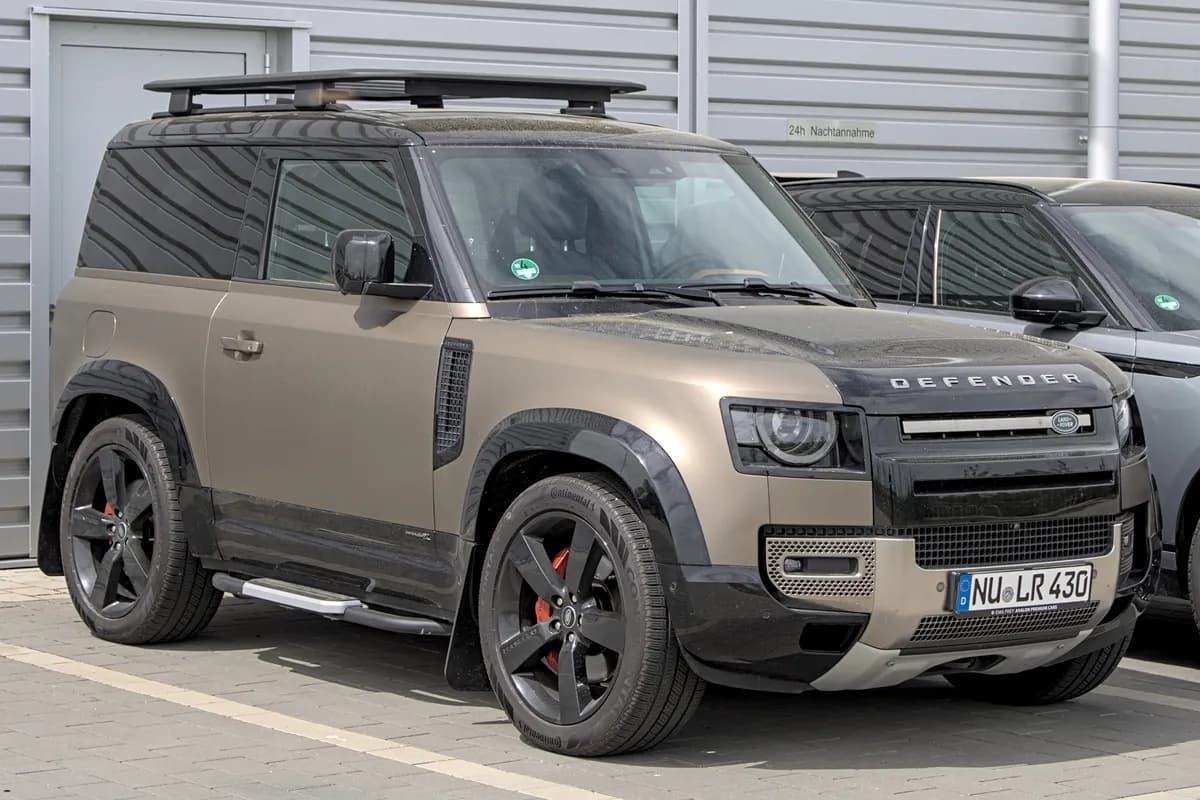 A bronze Land Rover Defender 90 SUV, front three-quarter view