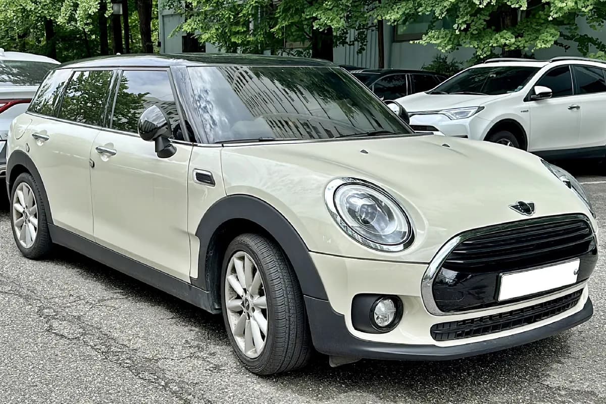 A white Mini Clubman wagon, front three-quarter view