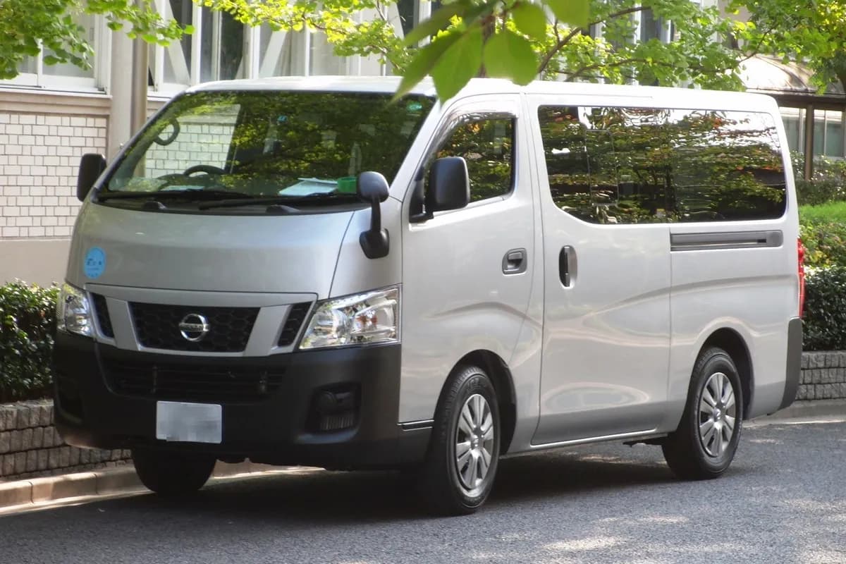 A silver Nissan NV350 Caravan van, front three-quarter view