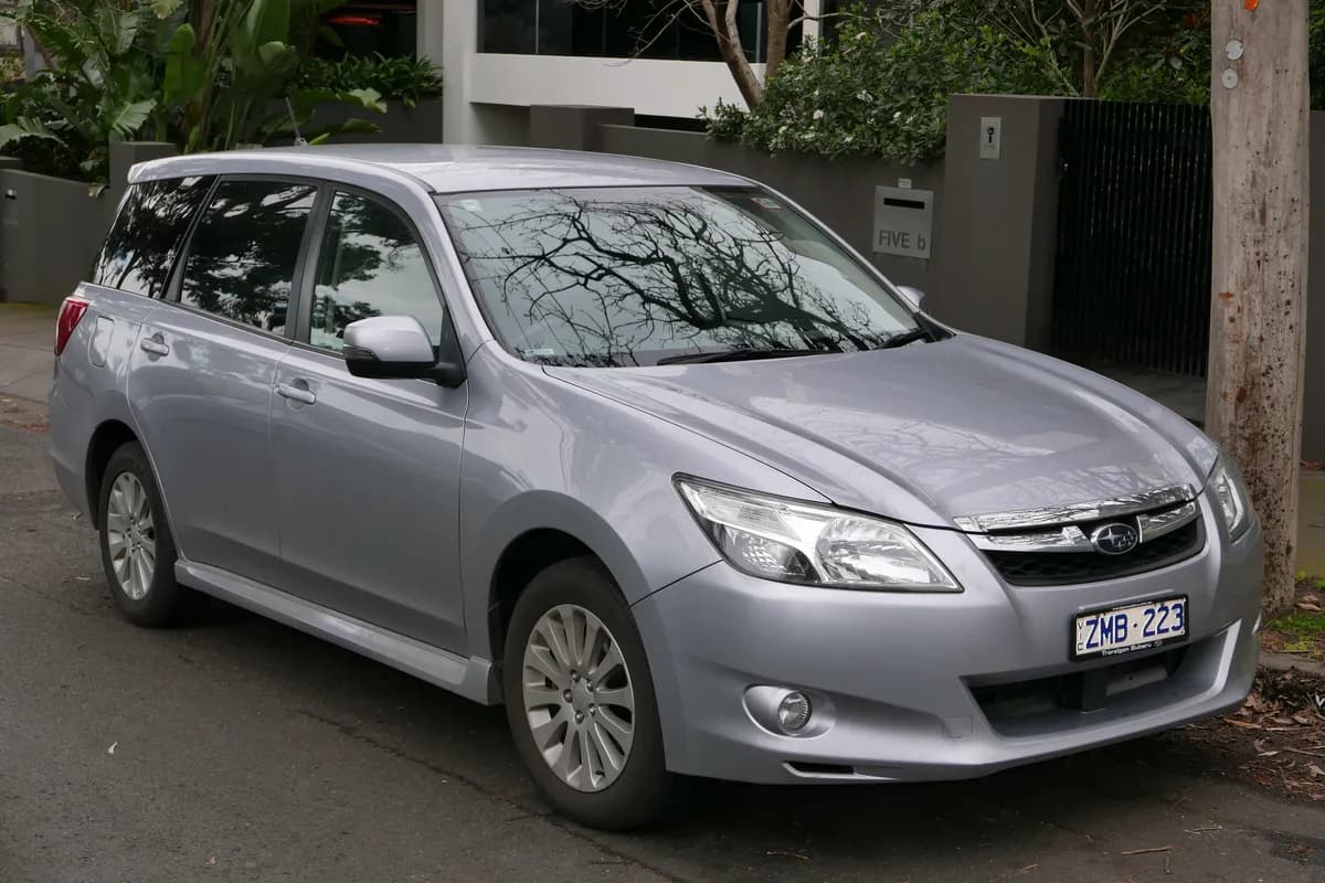 A silver Subaru Exiga wagon, front three-quarter view