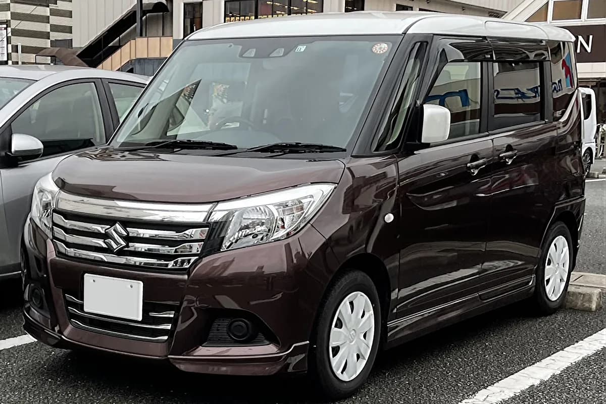 A brown Suzuki Solio hatchback, front three-quarter view