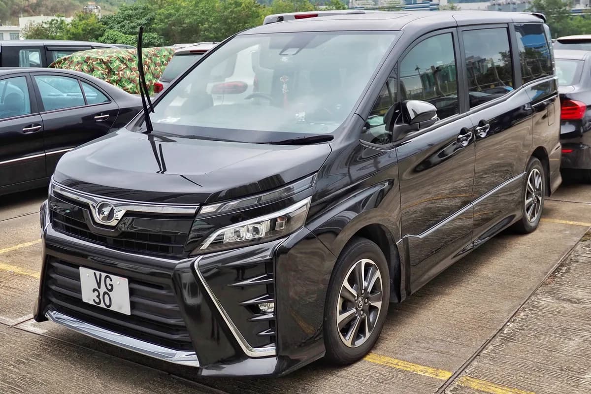 A black Toyota Voxy people mover, front three-quarter view